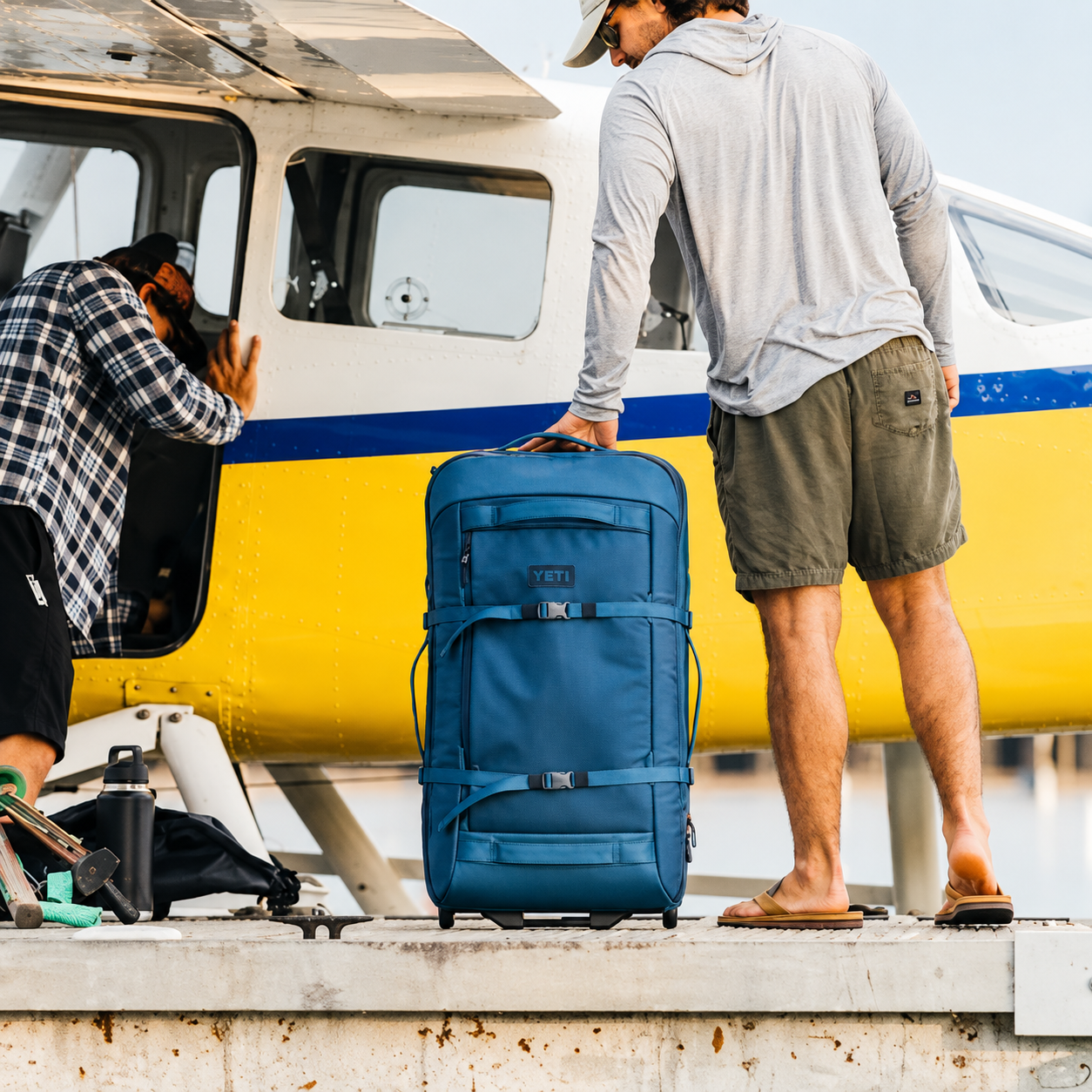 YETI Crossroads 29 inch checked luggage beside a floatplane